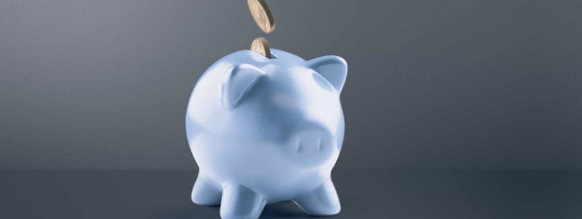 Blue piggy bank with coins going in