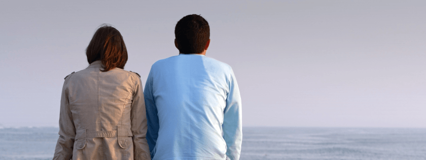 Couple sitting looking out to sea